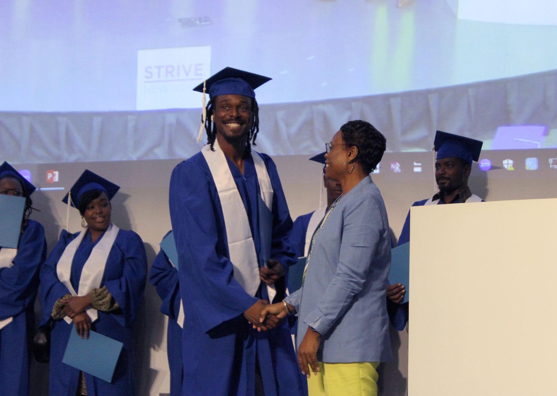 Brooklyn STRIVE graduation with a student on stage.