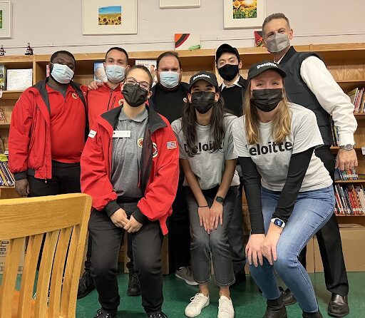 A group of 8 masked AmeriCorps members and Deloitte staff