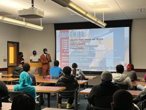 Students in a classroom look at a projected display outlining academic life at University of Maryland