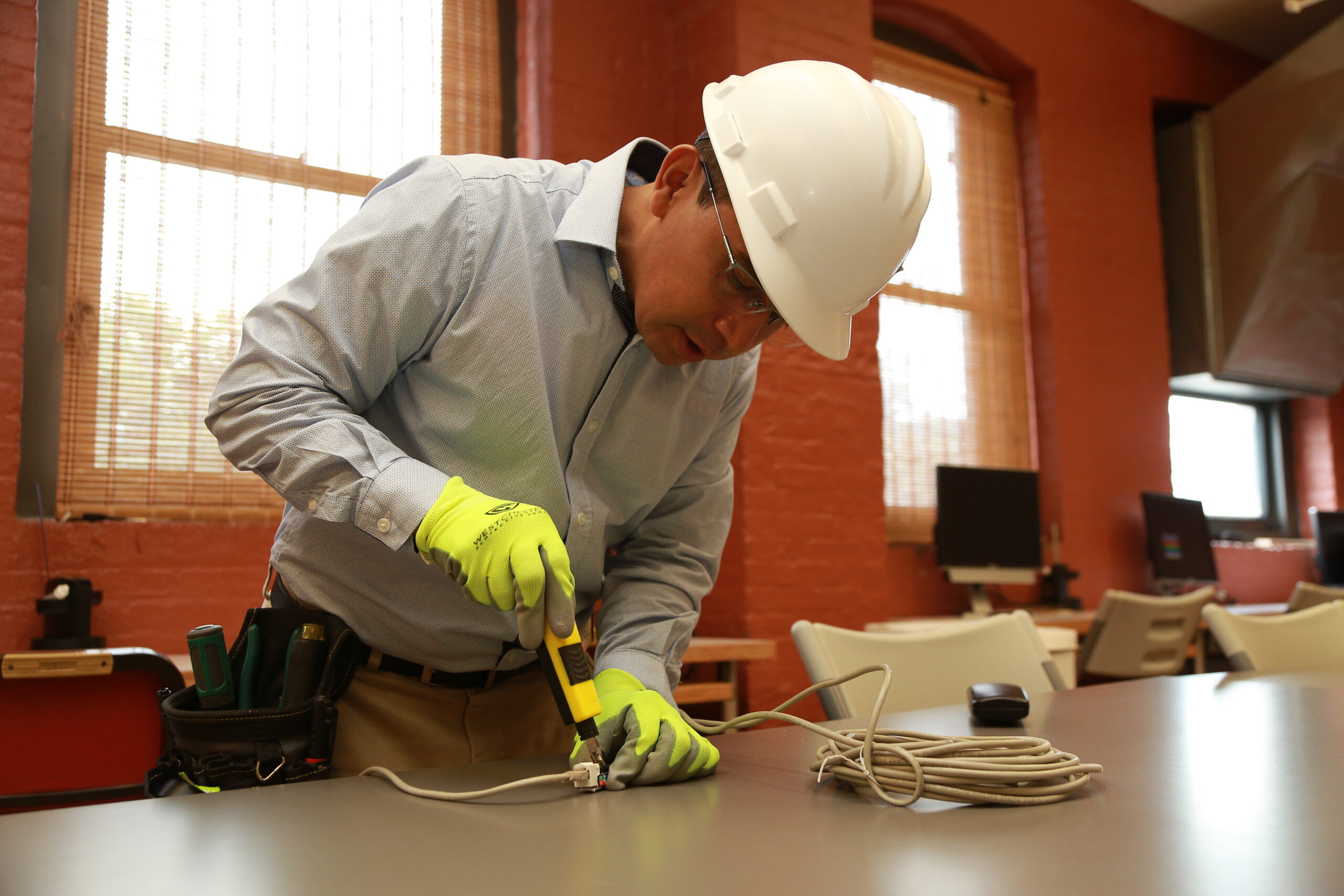 A student in Brooklyn Workforce Innovations' low-voltage cabling program