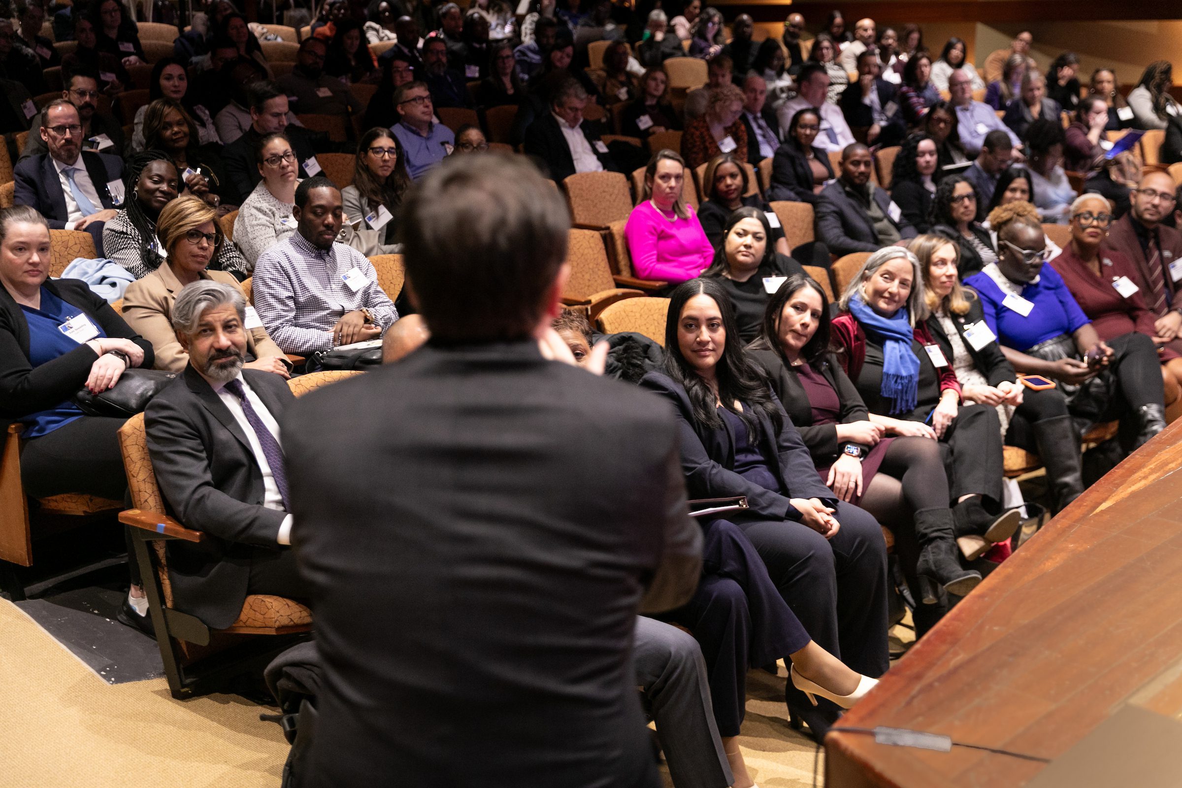 Greg Morris speaks to a crowd of attendees in an auditorium at the 2024 NYCETC Conference.